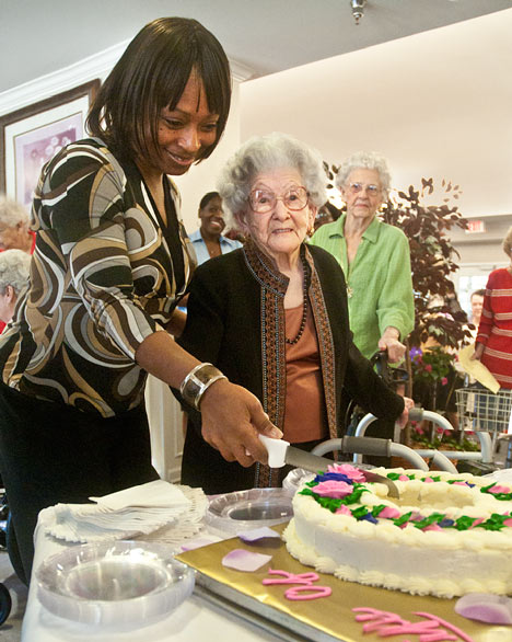 Nina Hunt and Lucille Montgomery cut the cake