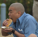 man eating po' boy sandwich